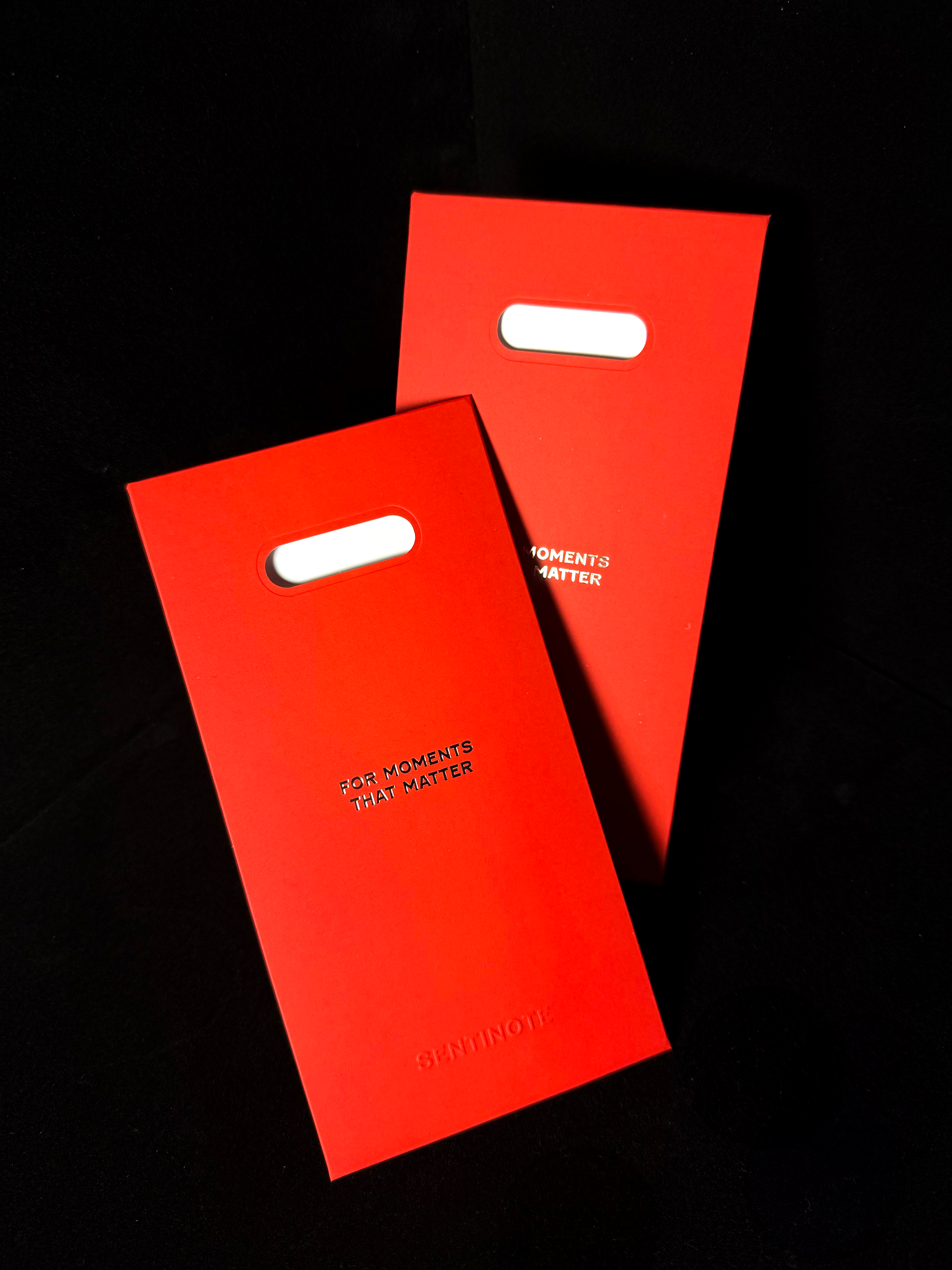 Two red envelope with text on a black background